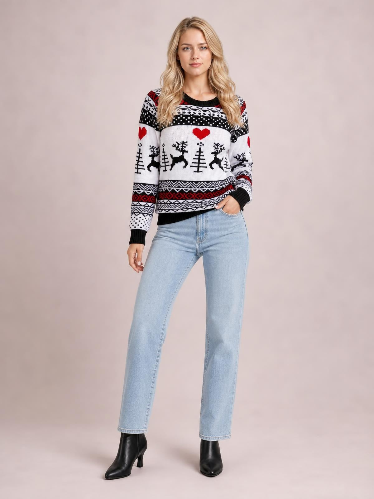 Model poses in a black, white, and red Christmas round neck sweater with long sleeves, festive reindeer and heart motifs, ribbed cuffs, and a relaxed silhouette.