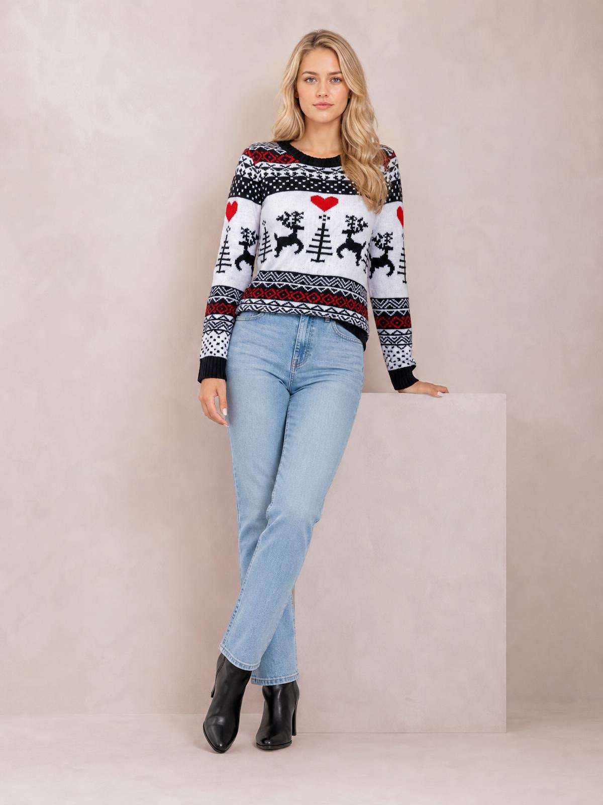 A model poses in a black, white, and red Christmas round neck sweater with long sleeves, ribbed trim, and festive reindeer and heart patterns.