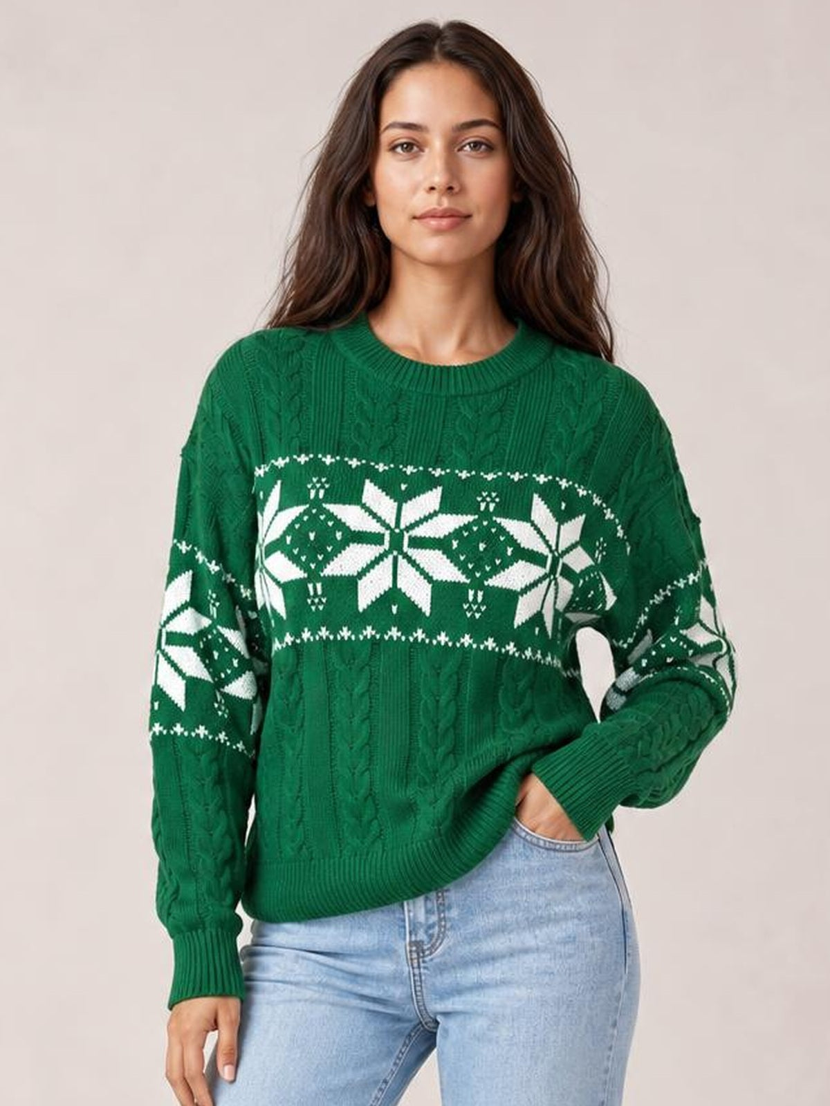 Model poses in a green Christmas snowflake cable-knit sweater with white patterned bands, ribbed crew neckline, cuffs and hem, and a relaxed silhouette.
