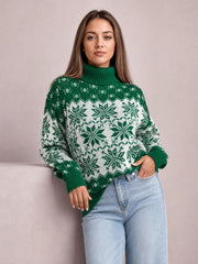 Model wears a green Christmas snowflake turtleneck sweater with long sleeves, ribbed cuffs and hem, a relaxed silhouette, and one hand in her jeans pocket.