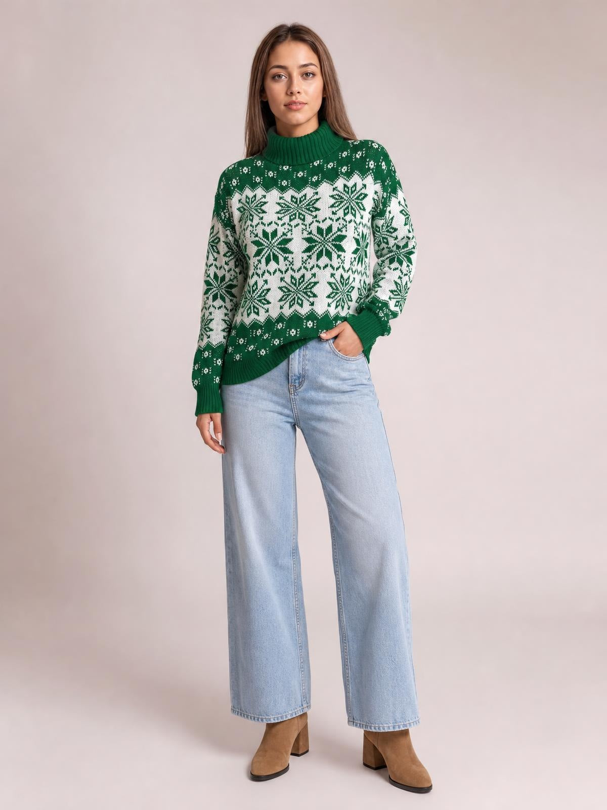 A model poses in a green and white Christmas snowflake turtleneck sweater with long sleeves, ribbed cuffs and hem, and a relaxed silhouette.