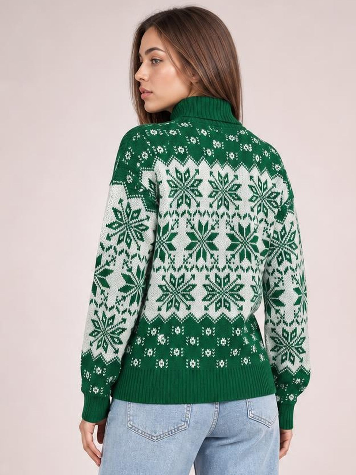 Model shown from the back in a green ribbed turtleneck sweater with long sleeves, snowflake patterning, and a relaxed silhouette.