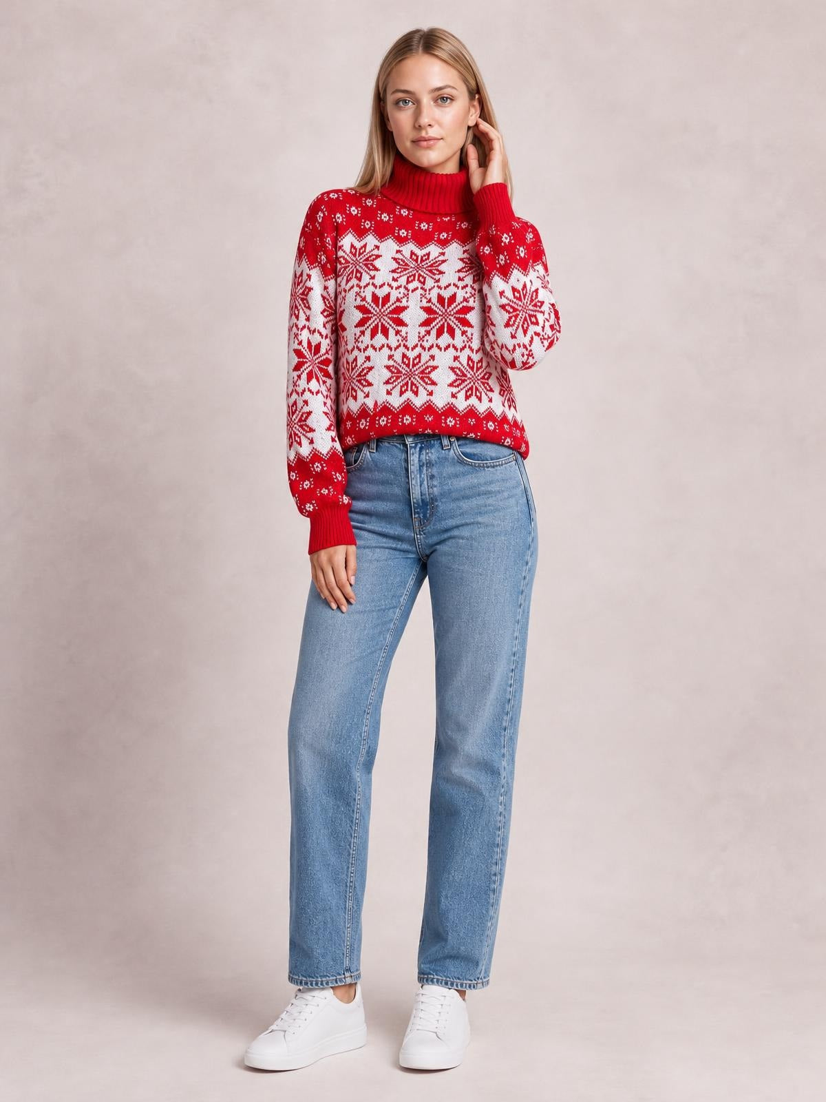 Model wears a red ribbed turtleneck sweater with white snowflake patterns, long sleeves, a relaxed silhouette, and ribbed cuffs and hem.