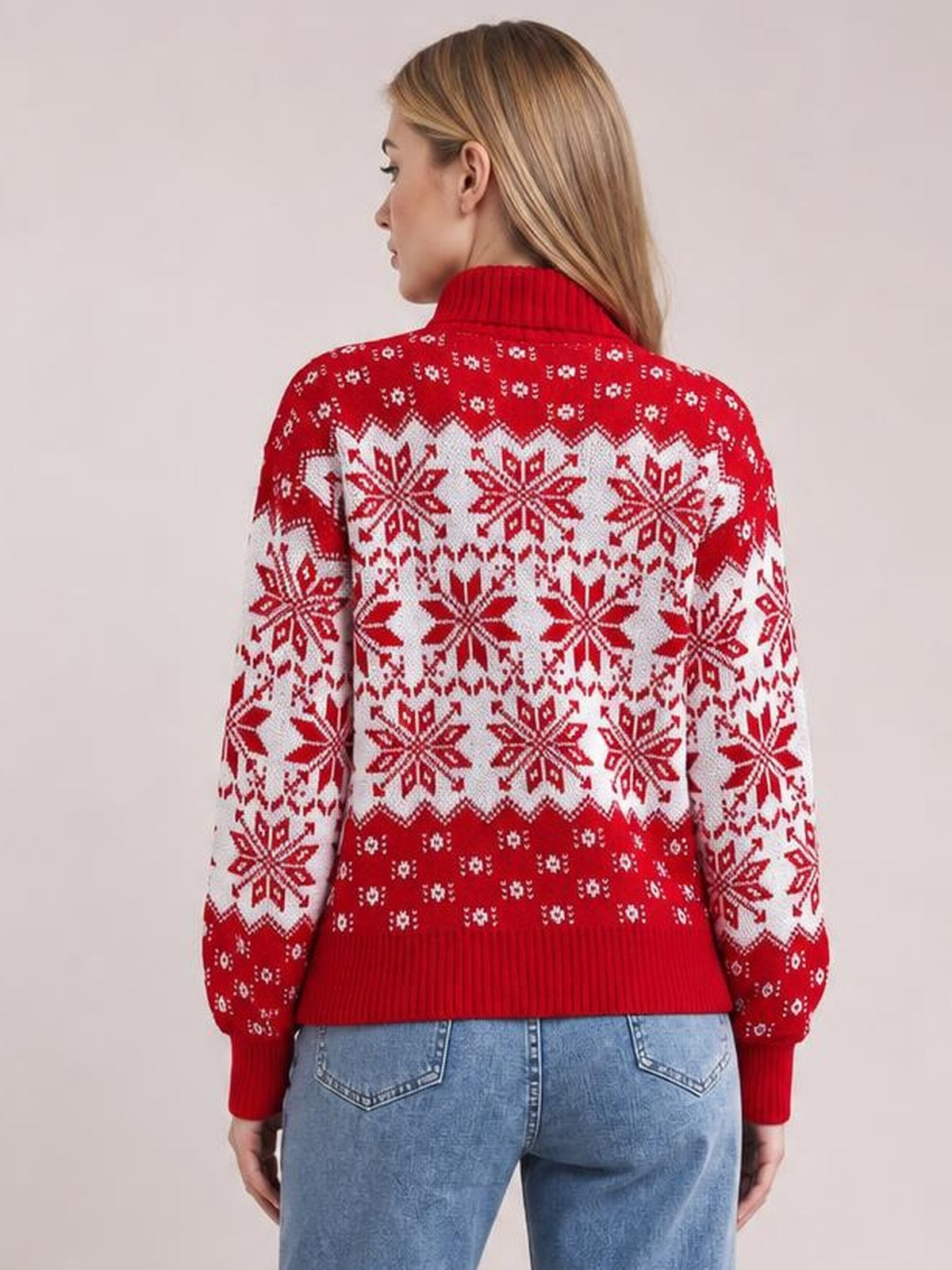 A model stands facing away in a red and white snowflake turtleneck sweater with long sleeves, ribbed collar, cuffs, hem, and a straight silhouette.