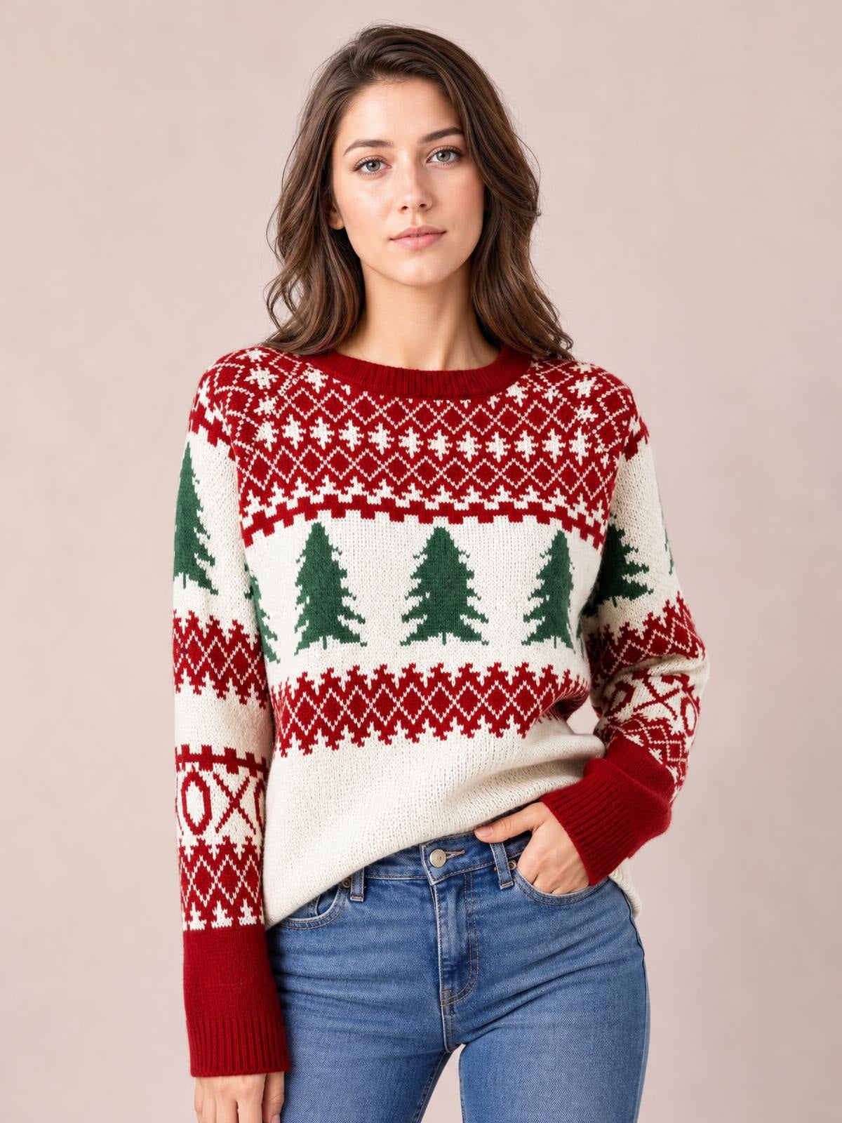 A woman poses in a relaxed cream Christmas tree pattern sweater with red and green Fair Isle detailing, round neck, ribbed cuffs, and a comfortable silhouette.