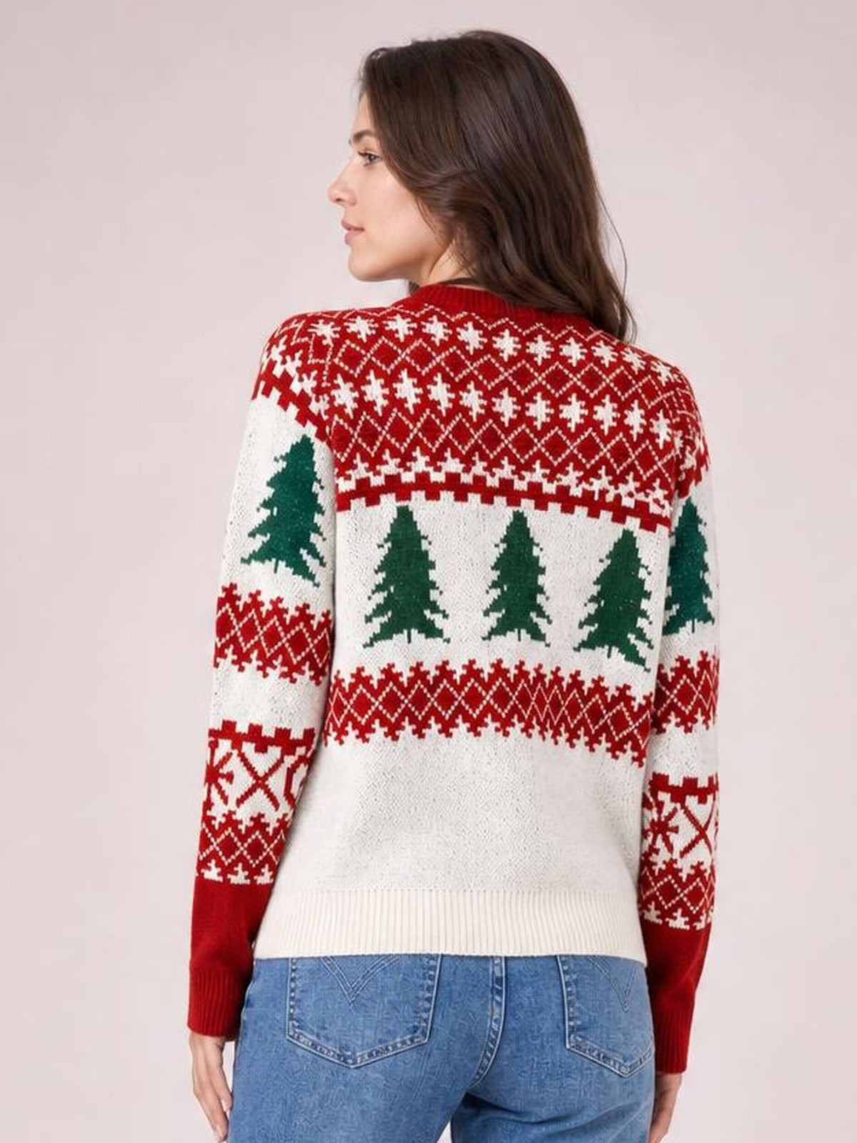 Model shown from the back wears a cream Christmas tree pattern sweater with a red-and-green Fair Isle design, ribbed round neck, cuffs, and hem.
