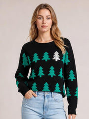 Model wearing a black Christmas tree sweater with a round neck, ribbed trim, long regular sleeves, and a regular silhouette.