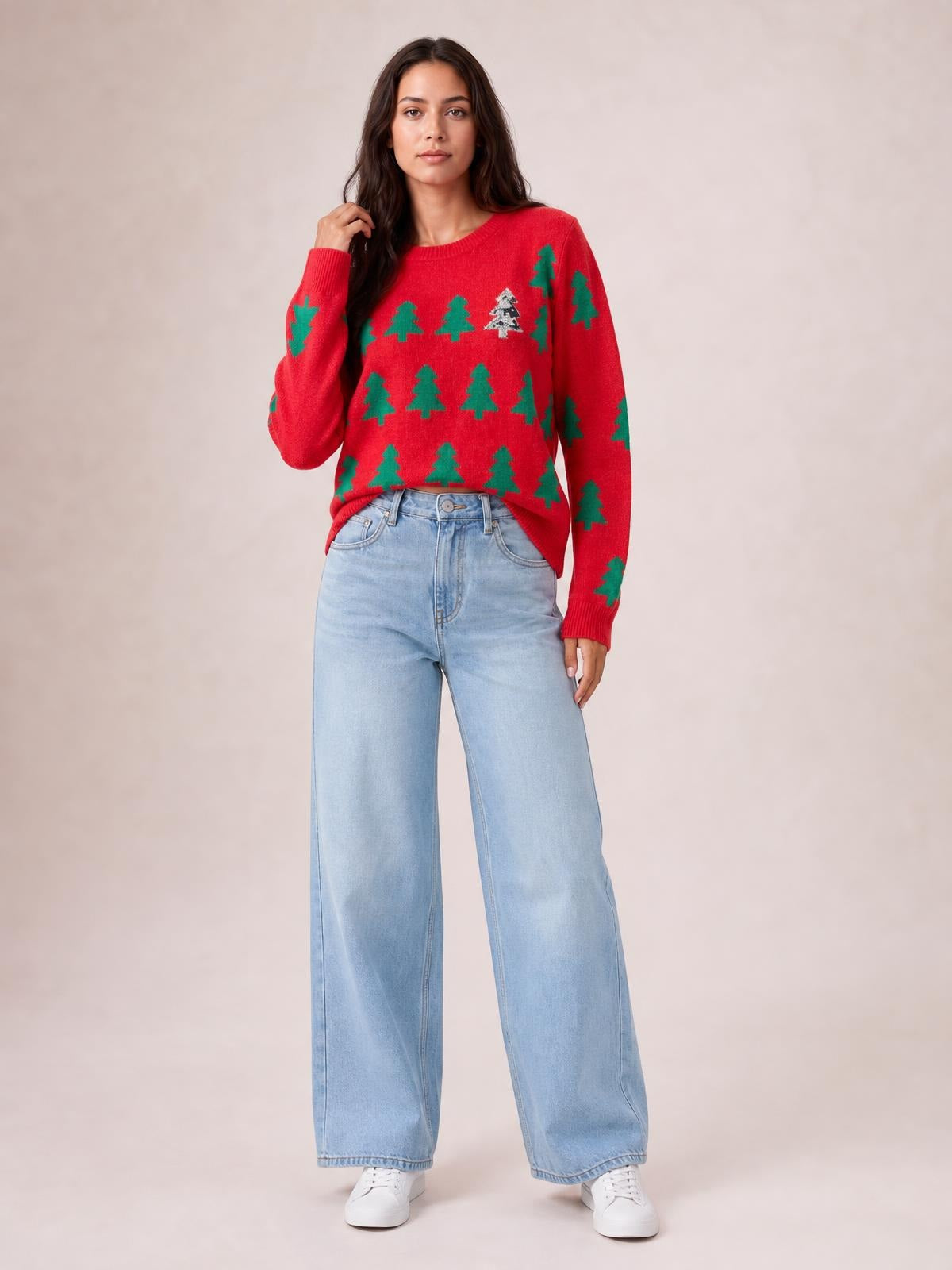 Model poses in a red Christmas tree sweater with a round ribbed neckline, long regular sleeves, ribbed cuffs and hem, and a relaxed regular silhouette.