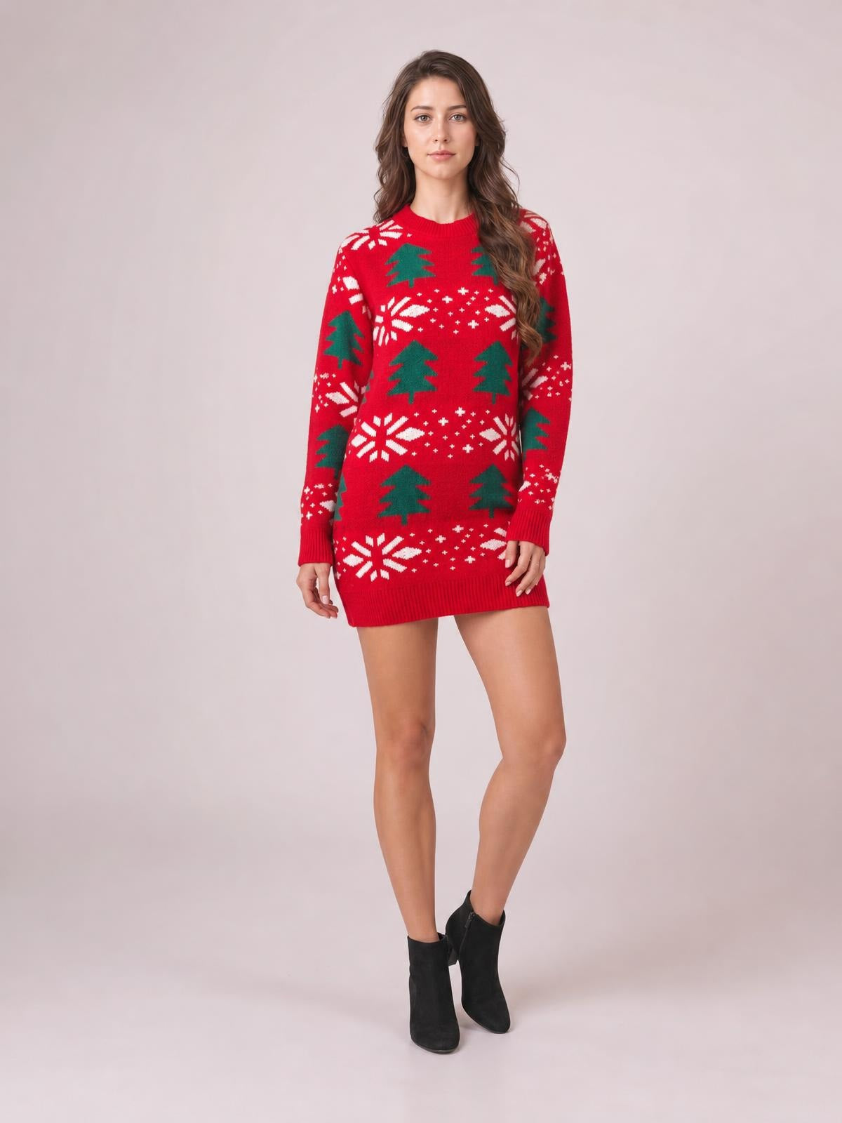 Model wears a red Christmas tree sweater dress with a round neck, long sleeves, festive green tree and white snowflake pattern, and a straight mini silhouette.