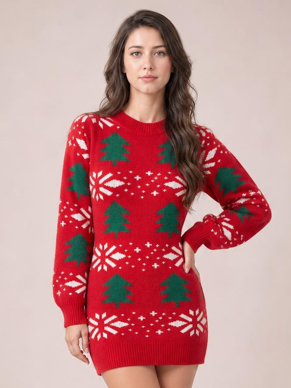 Model poses in a red Christmas tree sweater dress with a round neck, long sleeves, ribbed cuffs and hem, and a fitted mini silhouette.
