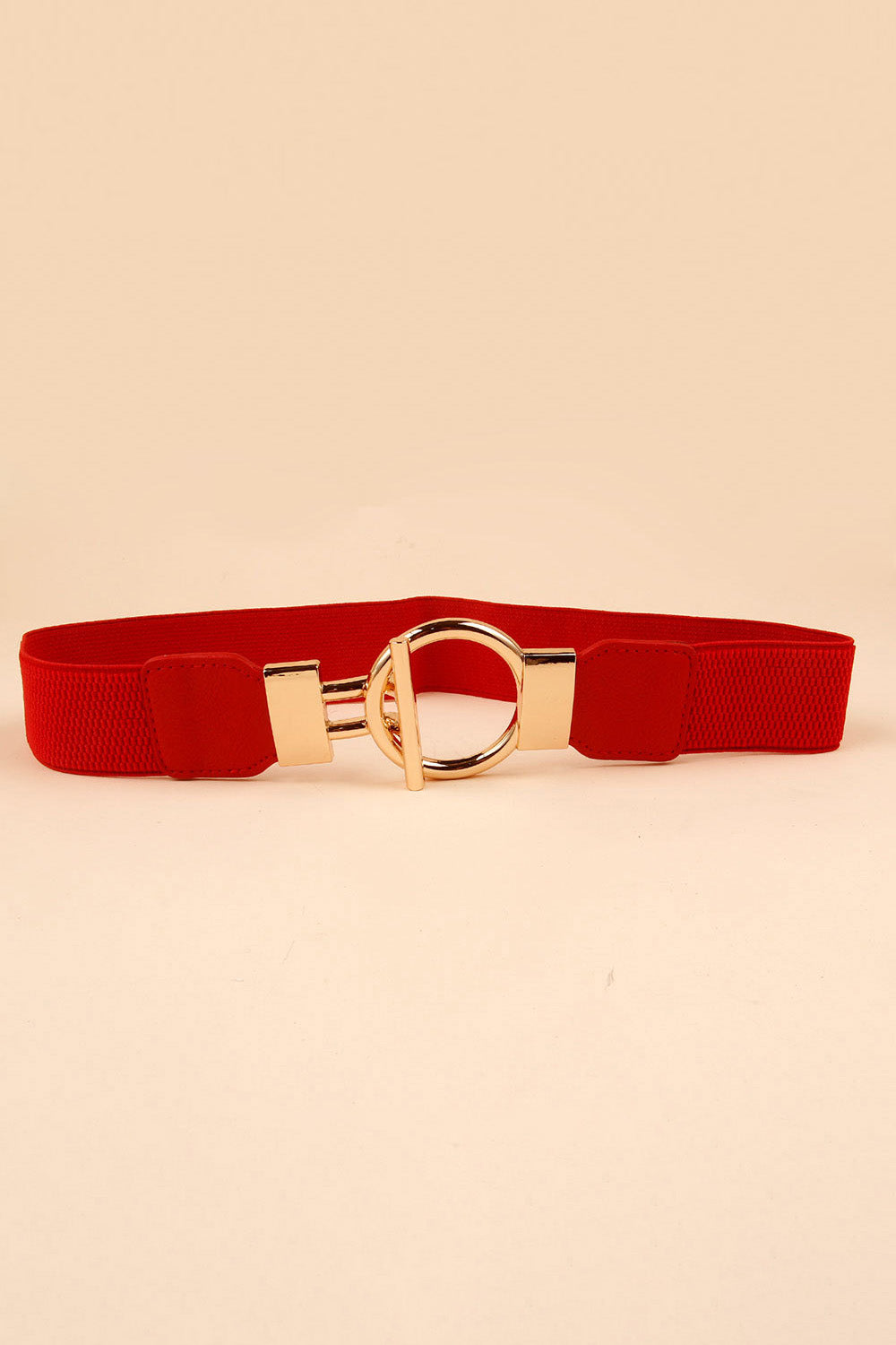 A red PU leather belt with a textured band features a prominent gold-tone circular zinc alloy buckle and polished hardware for a defined waist.