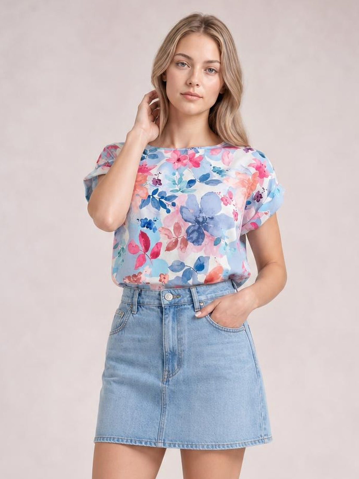 Model wearing a light blue floral Classic Rolled Sleeve T-Shirt with rolled short sleeves, a round neckline, and a relaxed straight silhouette.