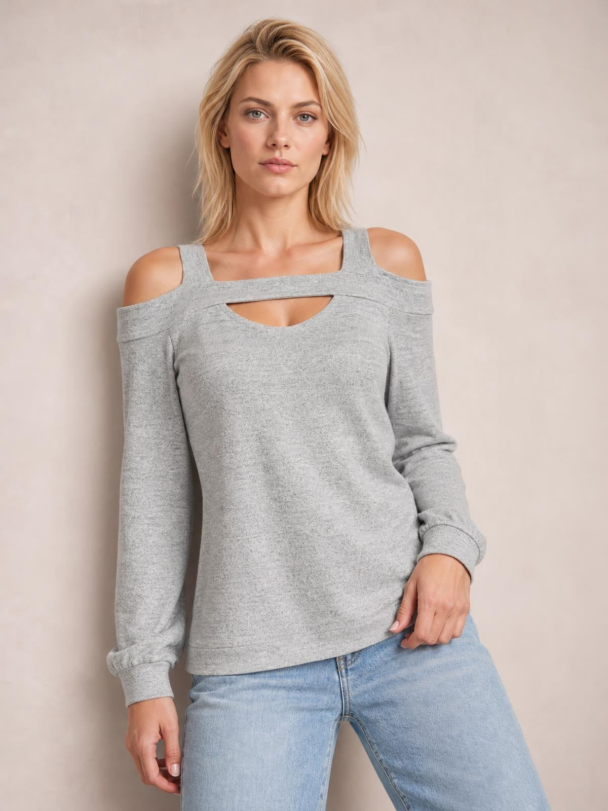 Model wears a gray cold shoulder blouse with a square neckline, upper chest cutout, long sleeves, and a relaxed straight silhouette.