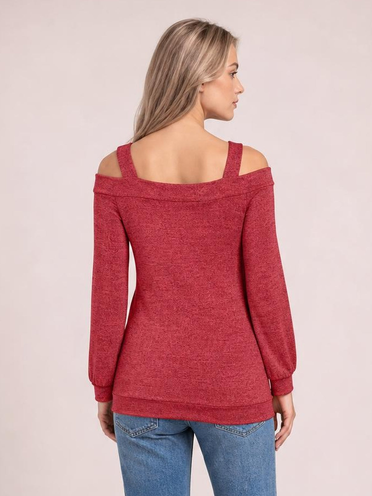Model turned away shows a red cold shoulder blouse with a square neckline, shoulder cutouts, long sleeves, and a fitted silhouette.