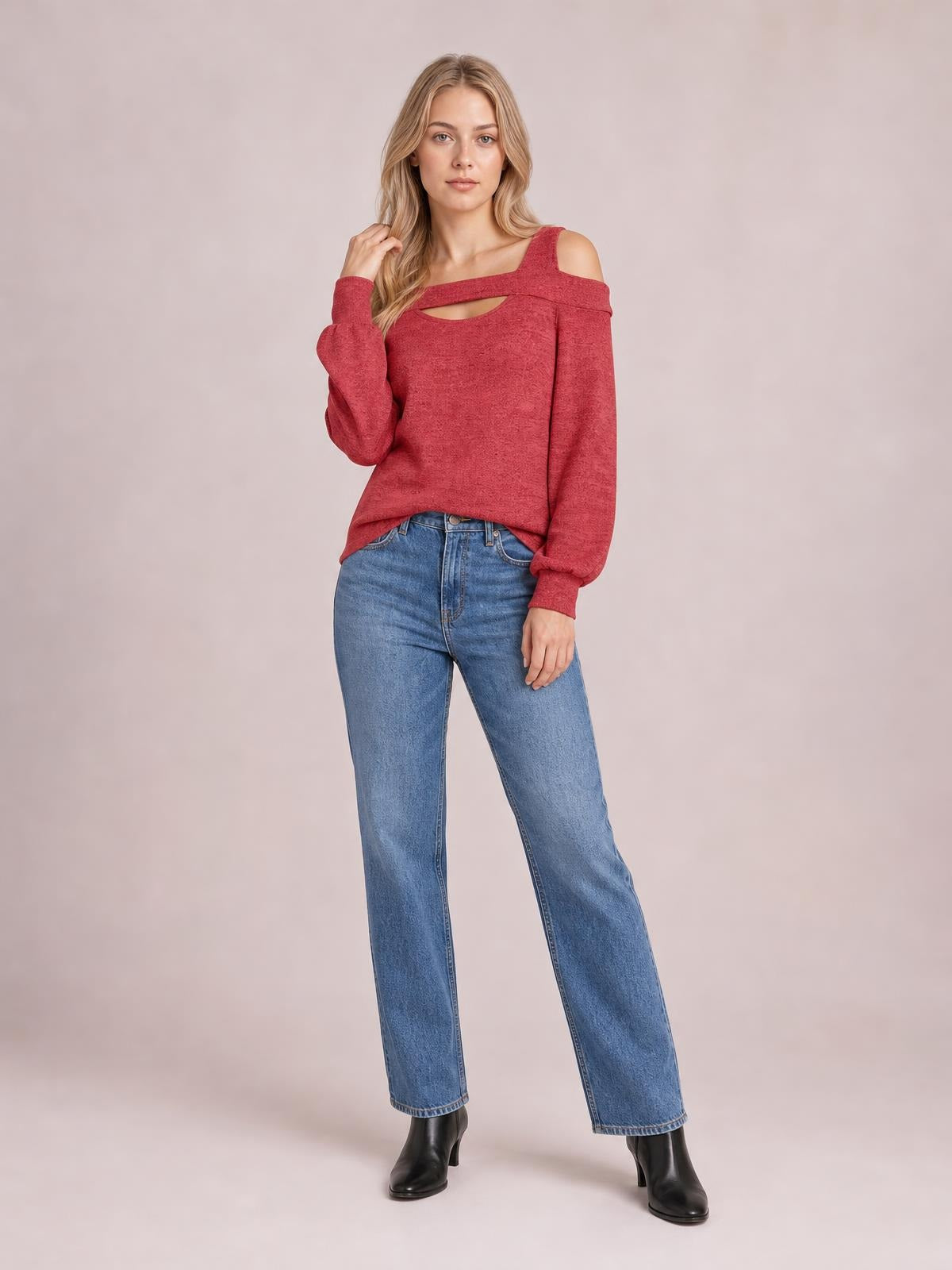 Model poses in a red cold shoulder cutout square neck blouse with long sleeves, a relaxed silhouette, and slightly asymmetrical hem.