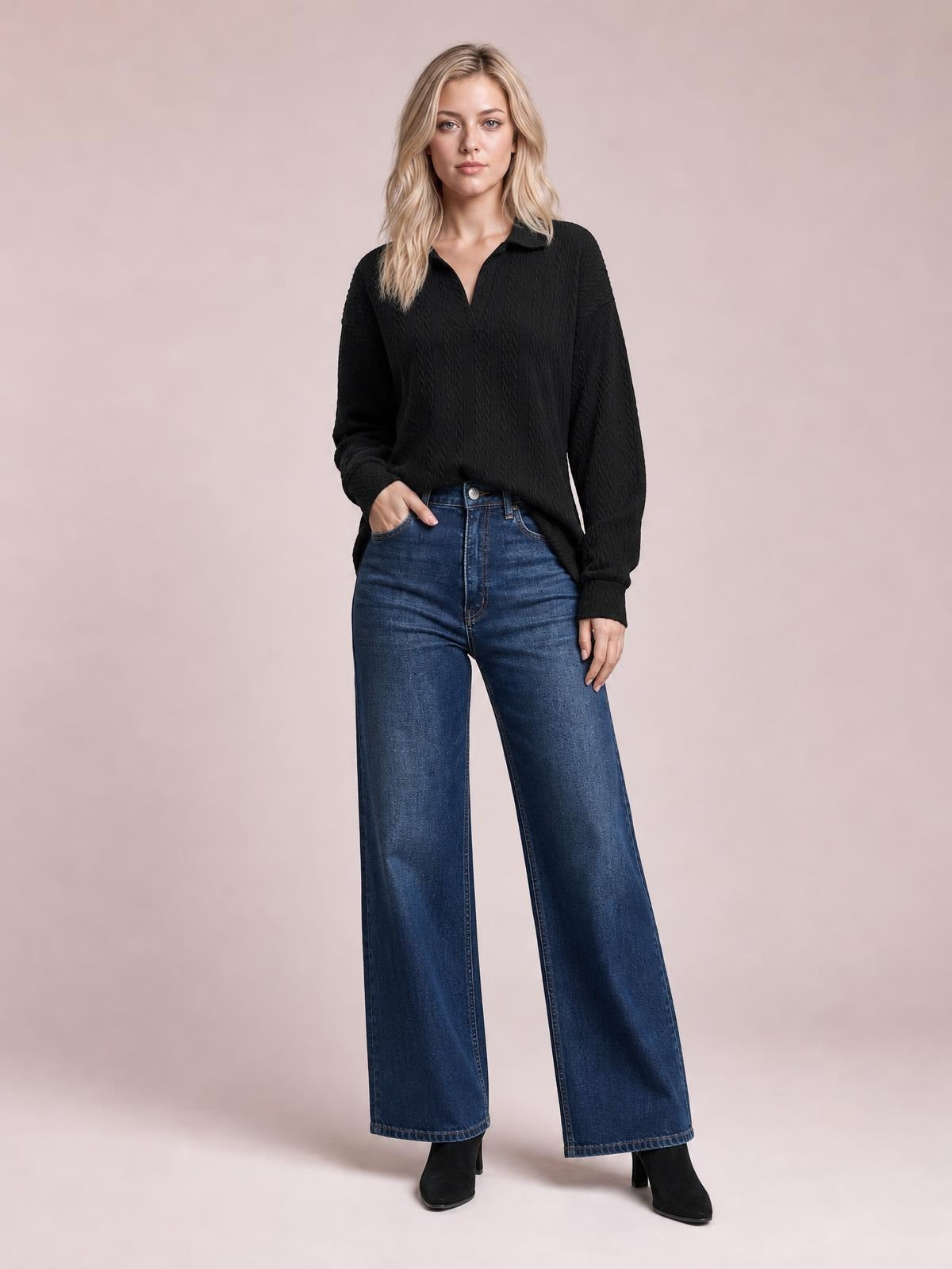 Model stands with one hand in her pocket wearing a black cable-knit blouse with a Johnny collar, long sleeves, and a relaxed regular silhouette.