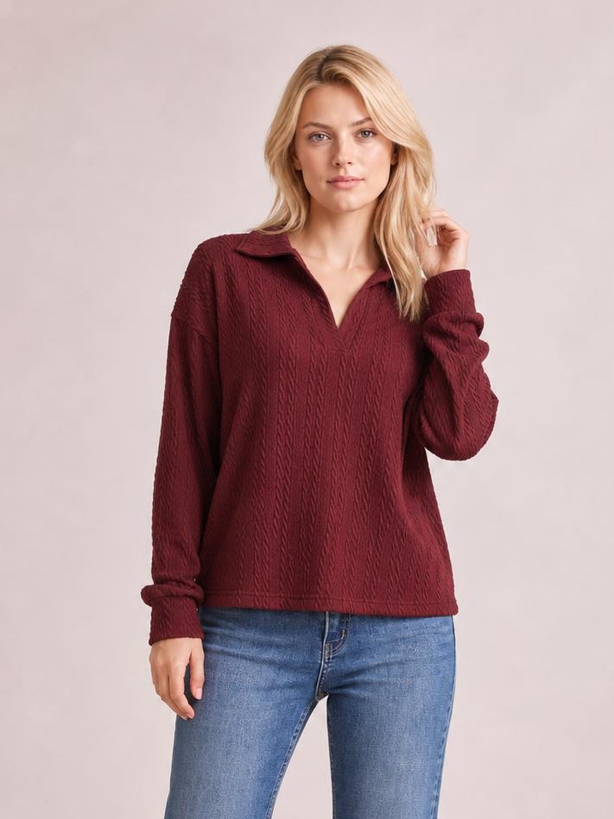 A model wears a burgundy solid cable-knit blouse with a Johnny collar, long sleeves, ribbed cuffs, and a relaxed regular-length silhouette.