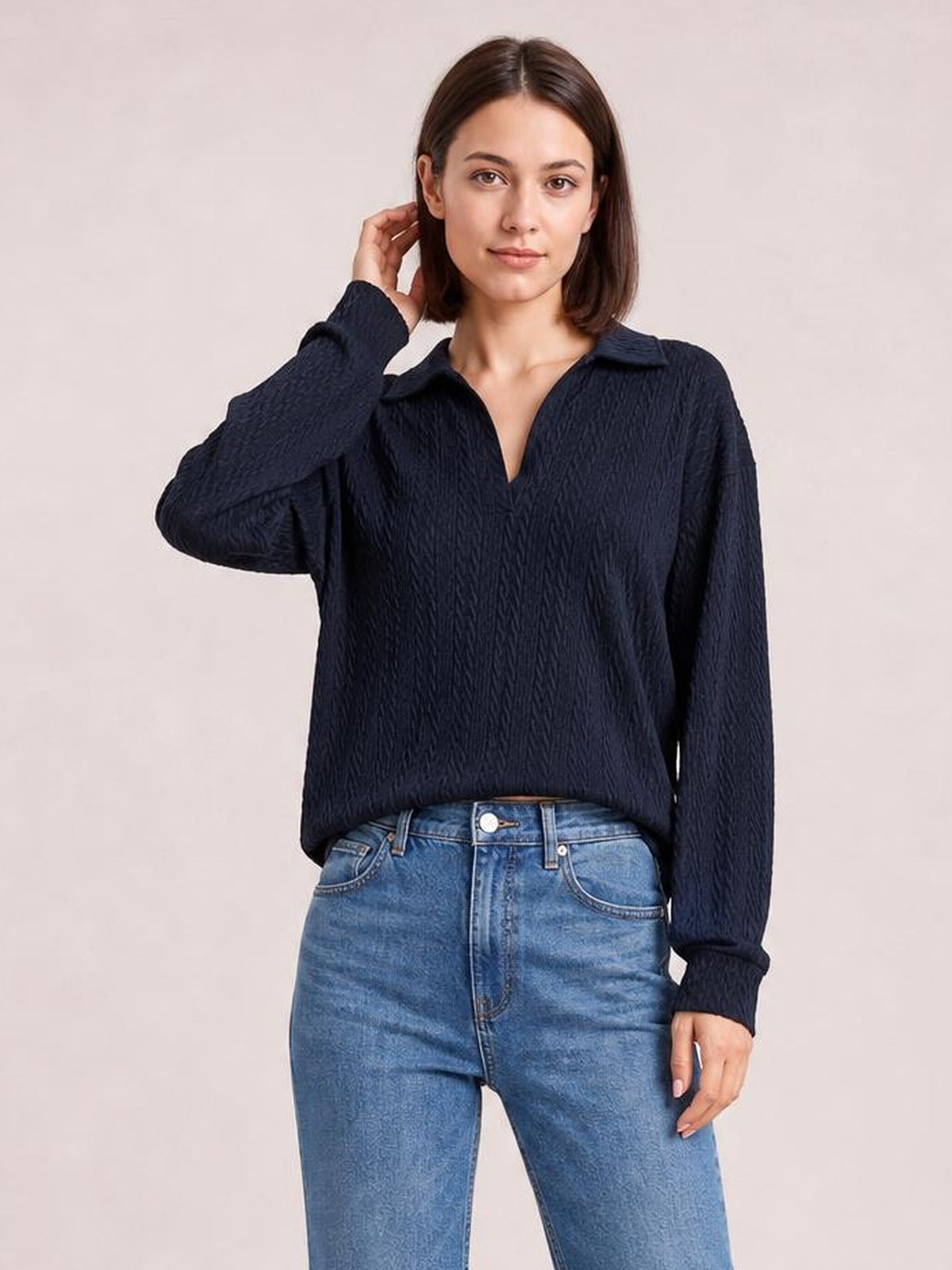 Model wearing a solid navy cable-knit blouse with a collared Johnny neckline, long regular sleeves, ribbed cuffs, and a relaxed regular-length silhouette.