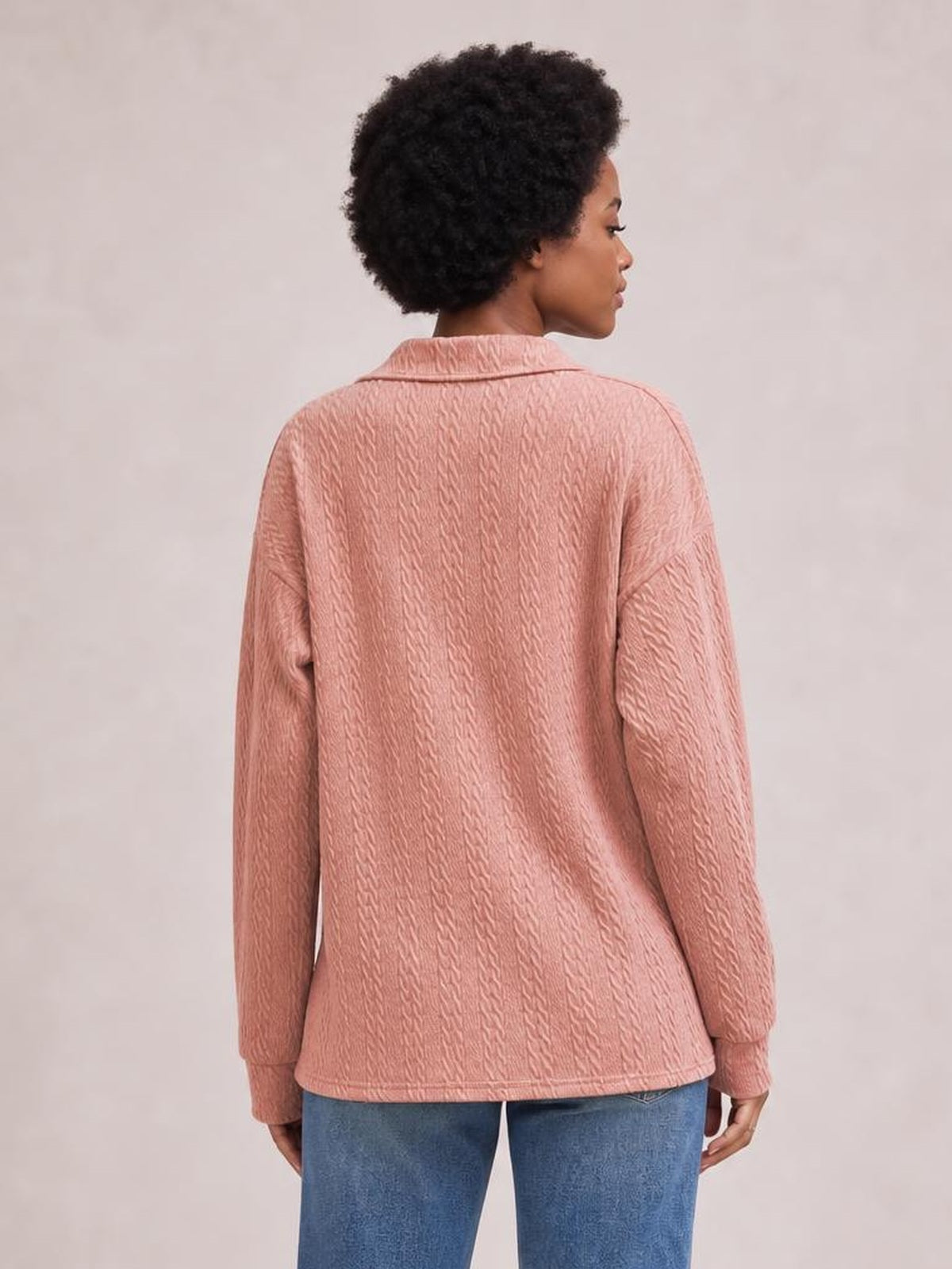 Model shown from behind wears a dusty pink cable-knit blouse with a Johnny collar, long regular sleeves, textured construction, and a relaxed regular-length silhouette.
