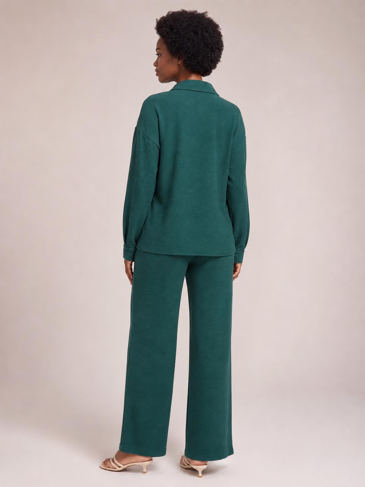 Model shown from the back in a teal collared long-sleeve top and matching wide-leg pants set, featuring a relaxed silhouette and cuffed sleeves.