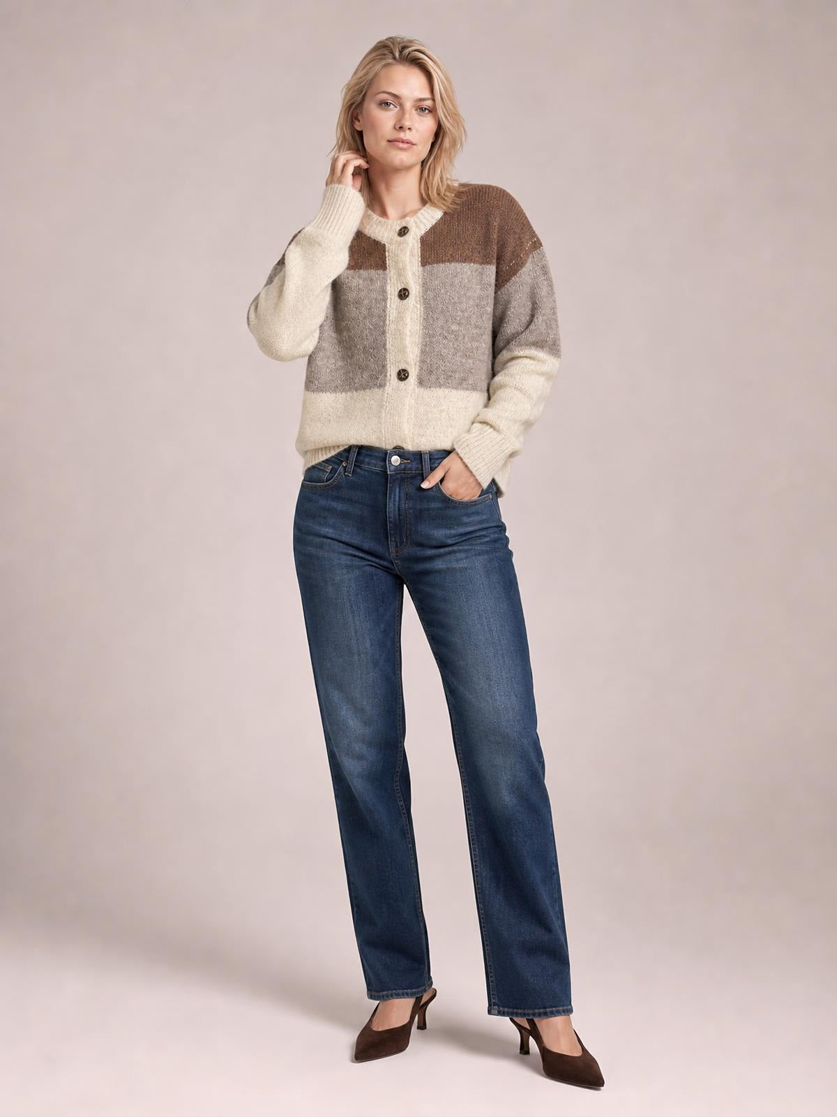 Model wearing a color block round neck button-up cardigan in cream, gray, and brown with long sleeves, ribbed trim, and a relaxed silhouette.