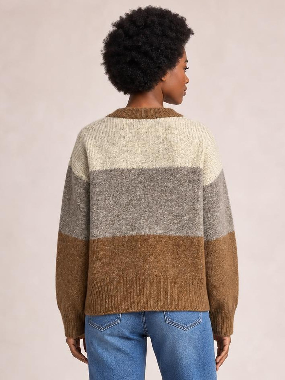 Model shown from the back in a color block button-up cardigan with a round neck, cream, gray, and brown panels, long sleeves, and ribbed trims.