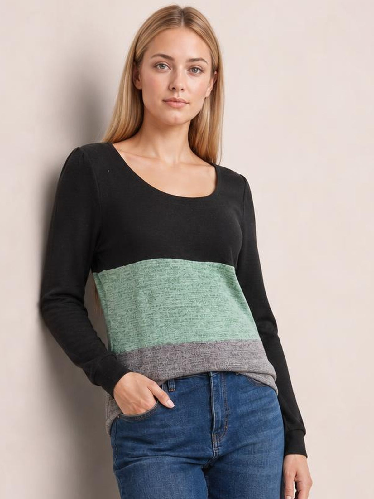 Model wears a fitted color block long sleeve T-shirt with a square neckline, black sleeves and top, mint green and gray horizontal panels, paired with jeans.