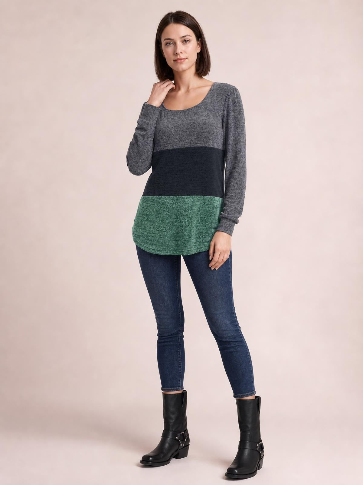 A model poses in a gray, black, and green color block long sleeve T-shirt with a square neckline, curved hem, and slightly fitted silhouette.