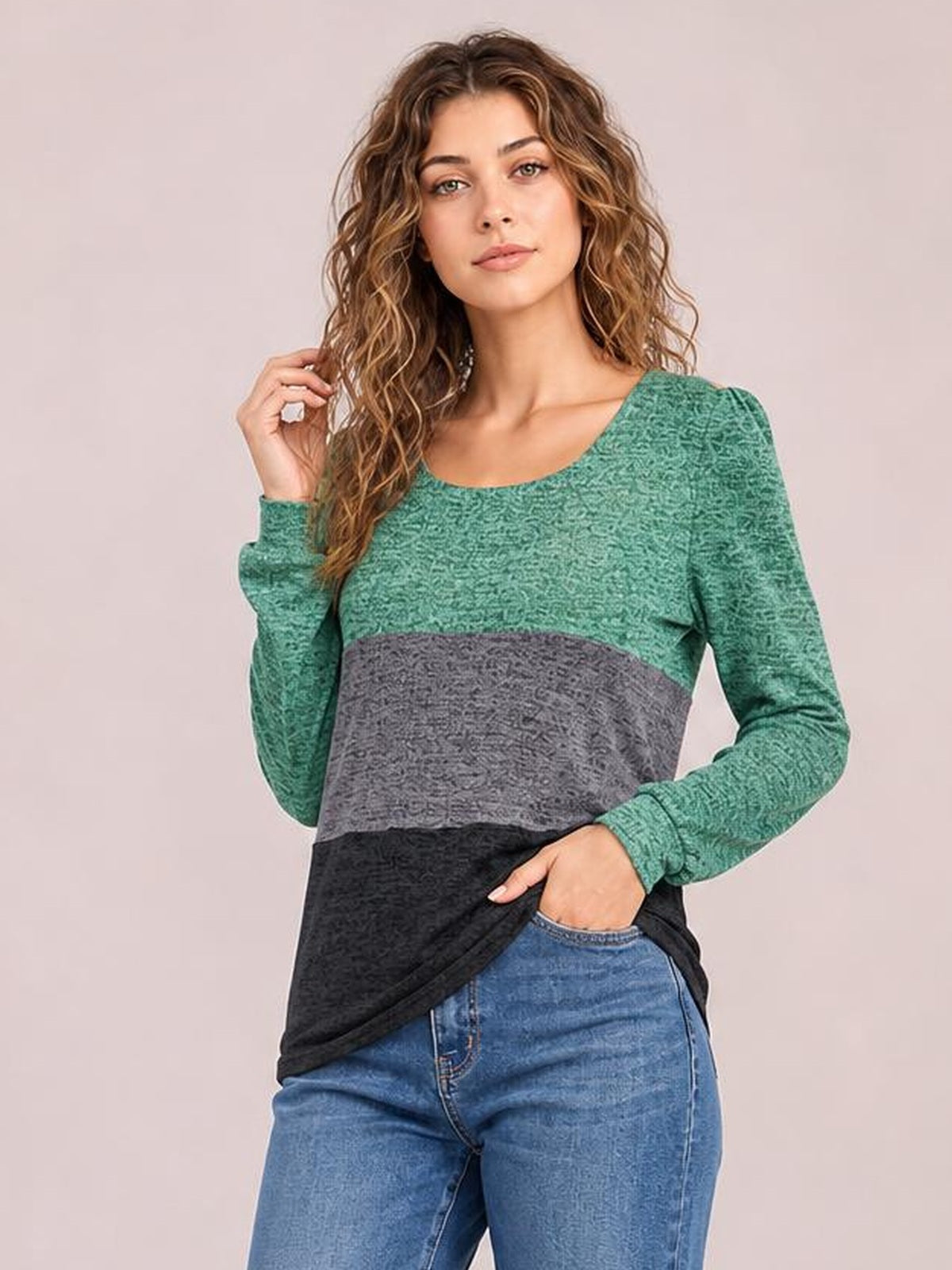 A model poses in a slightly fitted color block long sleeve T-shirt with a square neckline, green top, gray midsection, and black lower panel.