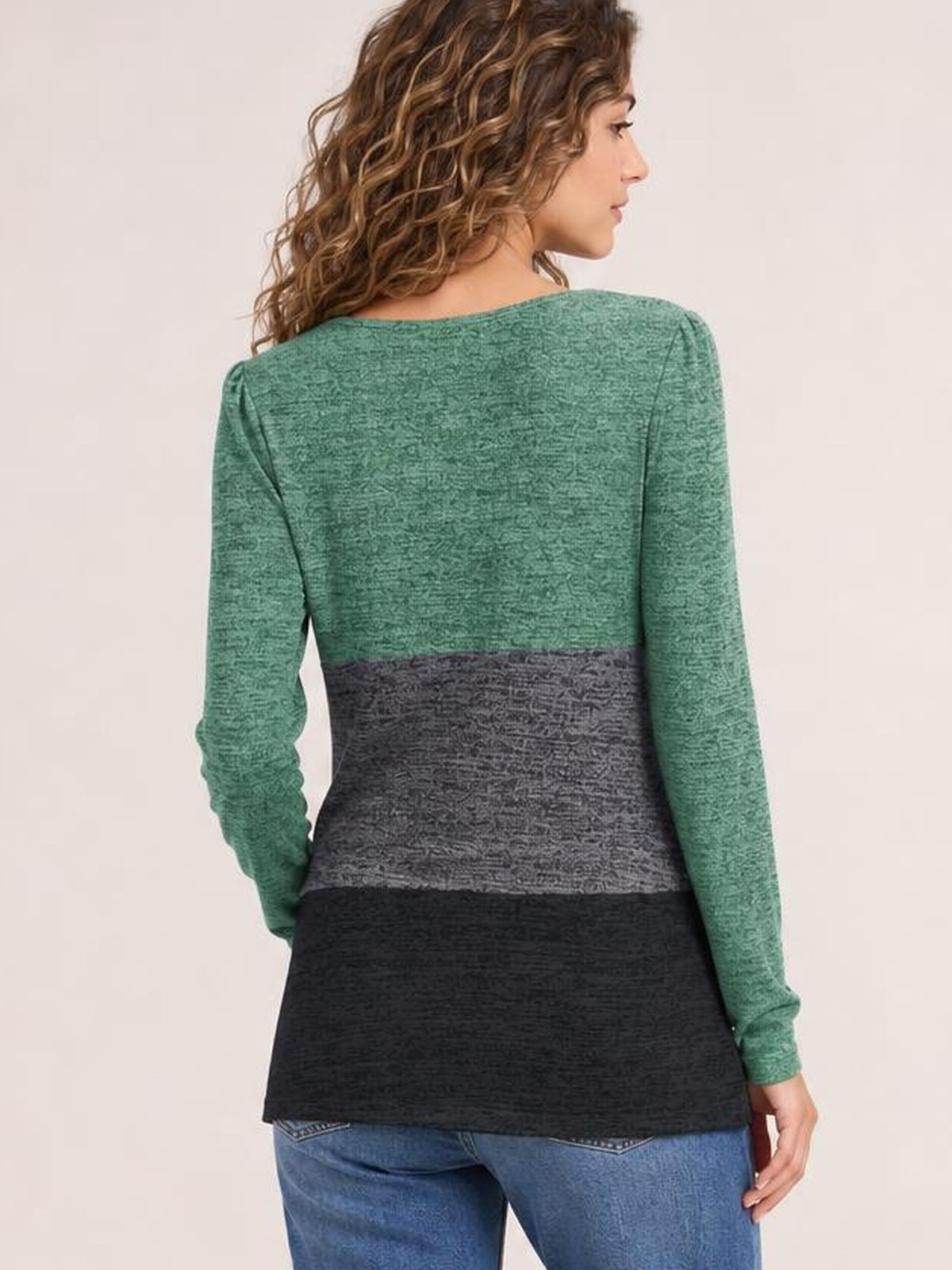 Model shown from behind wearing an opaque color block long sleeve T-shirt with green, gray, and black panels in a relaxed, straight silhouette.