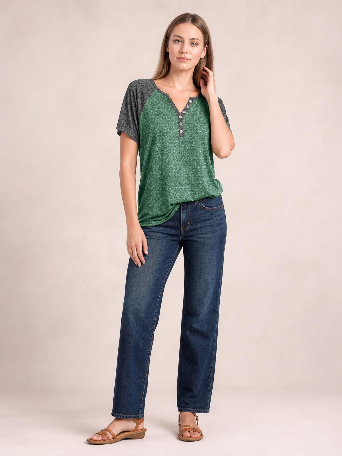 Model wears a green Contrast Notched Short Sleeve T-Shirt with charcoal raglan sleeves, a V-notch neckline, decorative buttons, and a relaxed silhouette.