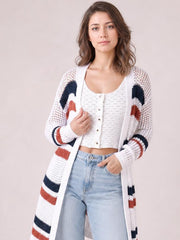 A model wears a white contrast openwork cardigan with navy and rust accents, long sleeves, an open front, and a long relaxed silhouette.