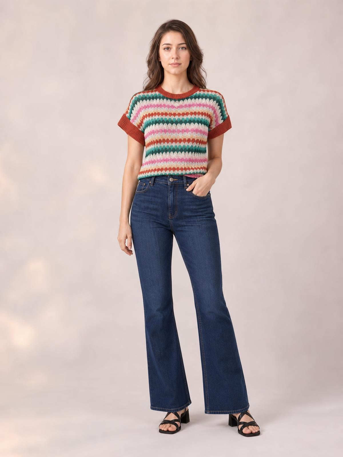 Model wears a multicolored contrast round neck short sleeve sweater with textured horizontal stripes, ribbed trim, and a relaxed waist-length silhouette.