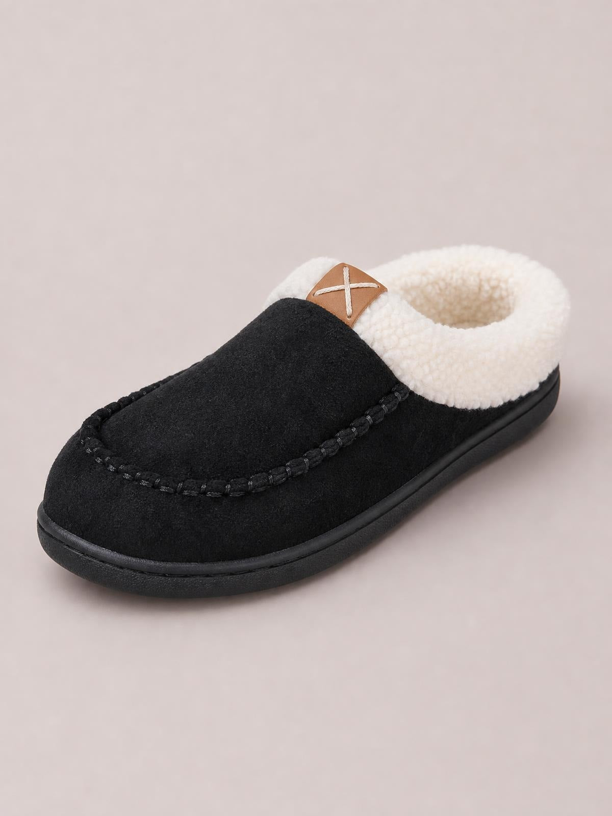 Black round-toe flat slipper with a soft white fluff lining, contrast trim, moc-toe stitching, and a sturdy black TPR sole.