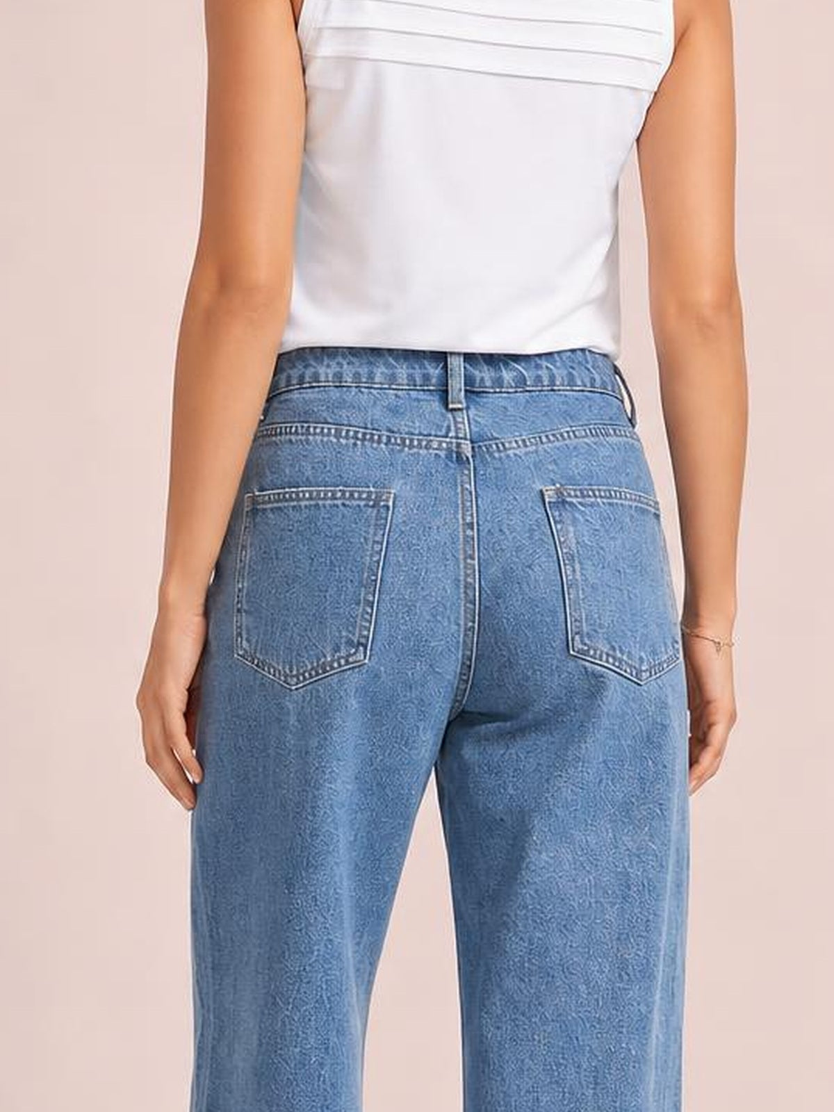 Model shown from behind wearing blue contrast straight-leg jeans with a waistband, belt loops, seam detailing, and two back pockets.