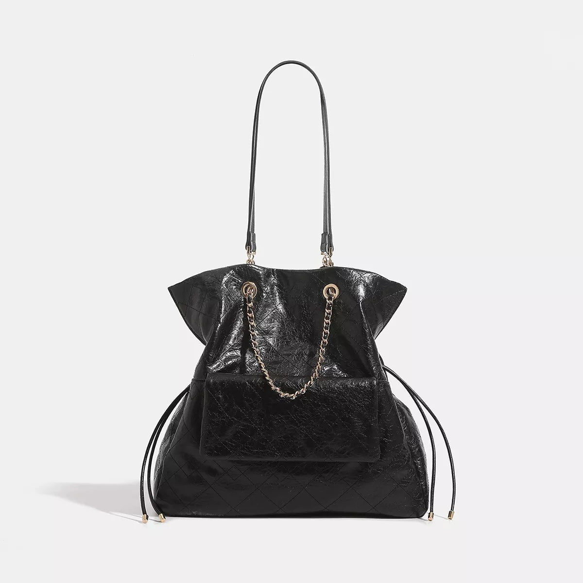Large black PU leather convertible drawstring backpack bag with a slouchy silhouette, quilted texture, front pocket, chain detail, and long shoulder straps.