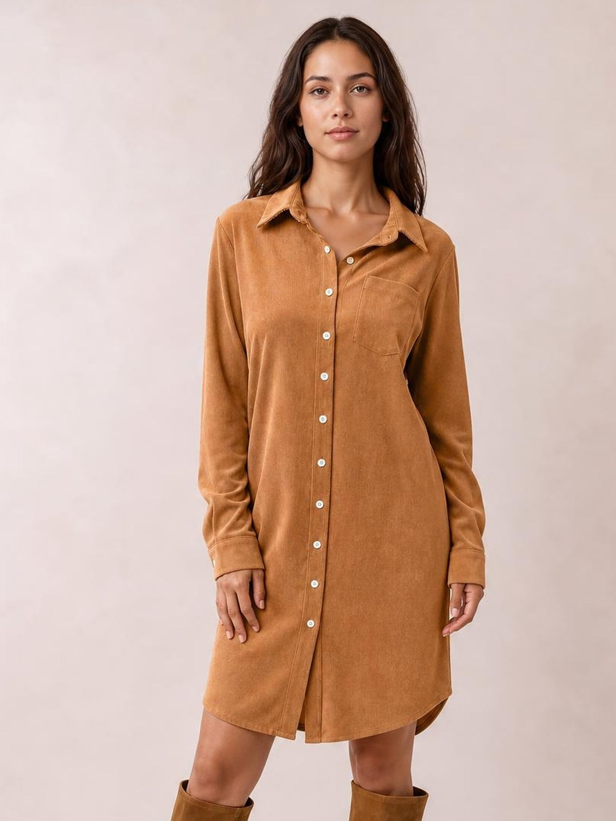 A model stands in a camel corduroy shirt dress with a collared button-down front, long sleeves, chest pocket, and relaxed straight silhouette.