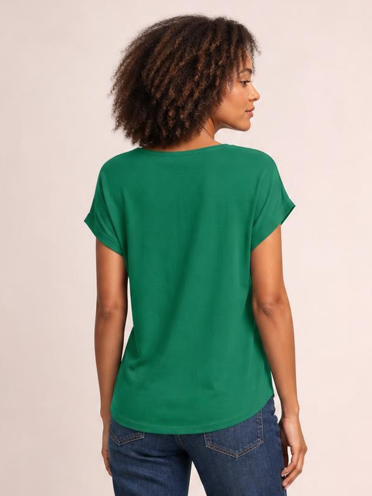 A model wears a green short-sleeve T-shirt with a relaxed, straight silhouette and smooth opaque construction, shown from the back in profile.