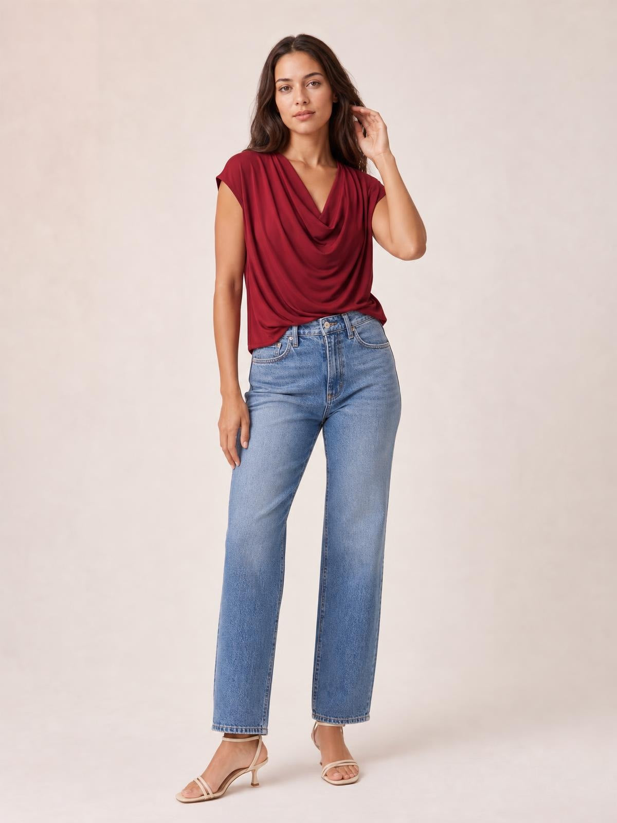 Model poses in a burgundy cowl neck short sleeve T-shirt with an elegant draped front, relaxed silhouette, and softly gathered construction.