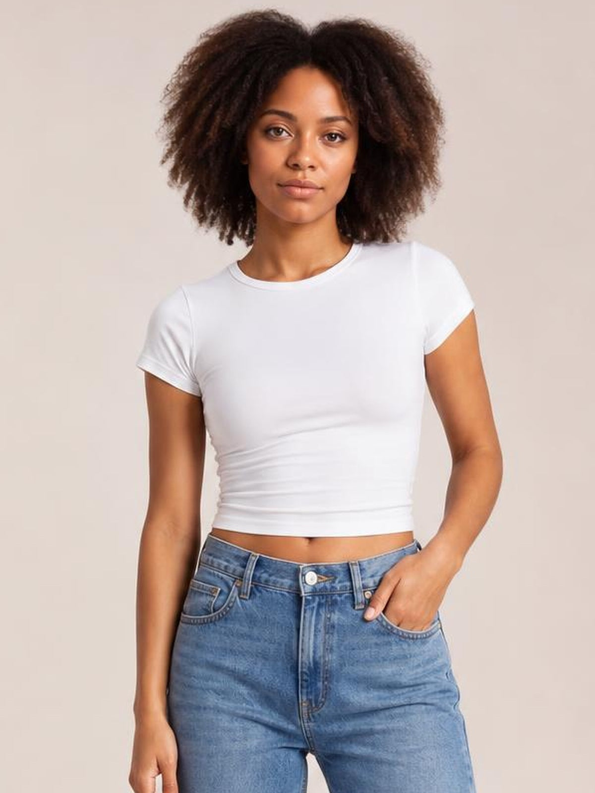 Model poses in a white solid crewneck short sleeve tee with a fitted silhouette, regular sleeves, clean construction, and a cropped-looking hem.