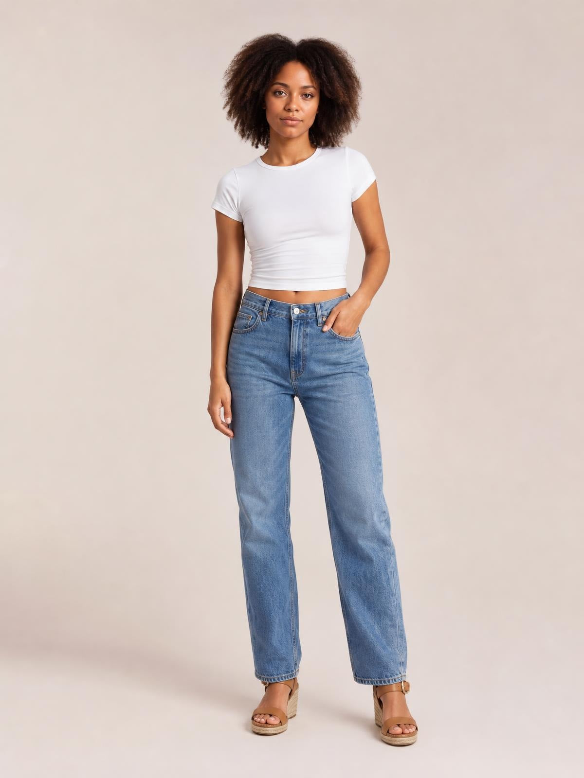 A model stands in a solid white Crewneck Short Sleeve Tee with a round neckline, fitted silhouette, short regular sleeves, and a straight hem.