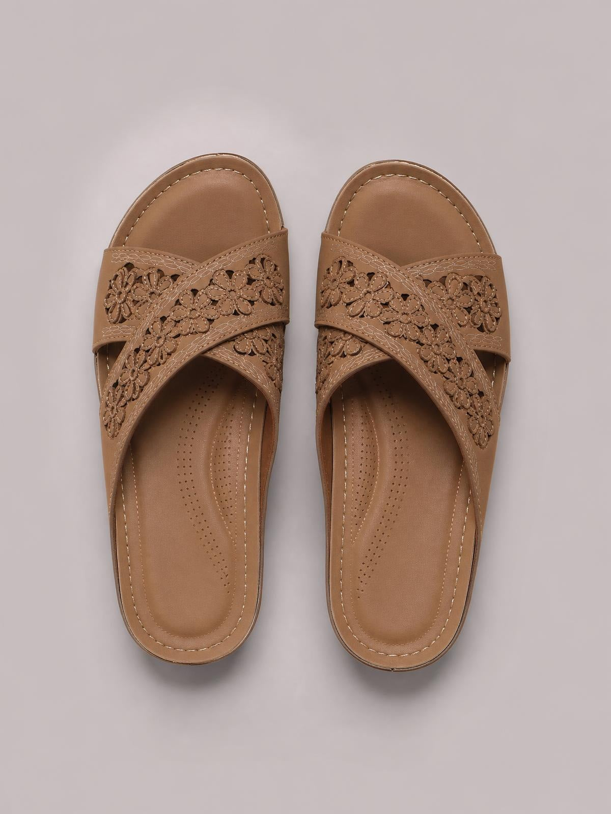 Tan PU leather crisscross flower wedge sandals feature layered floral cutout straps, cushioned footbeds, stitched edges, and comfortable low heels.
