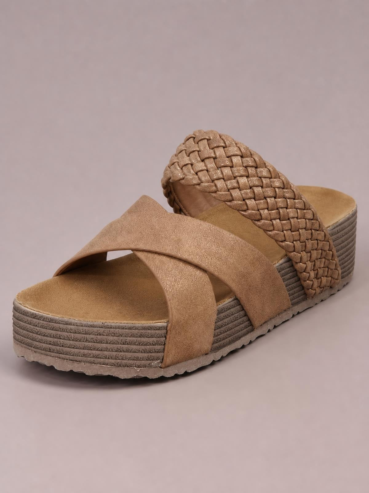 Tan crisscross open toe platform sandals feature wide crossover straps, a textured woven back strap, cushioned footbeds, and layered flat platform soles.