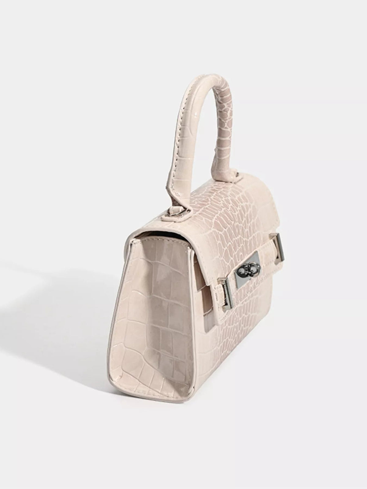 Small cream PU leather top-handle handbag with croc embossing, a structured silhouette, rounded handle, flap closure, and polished metal clasp.