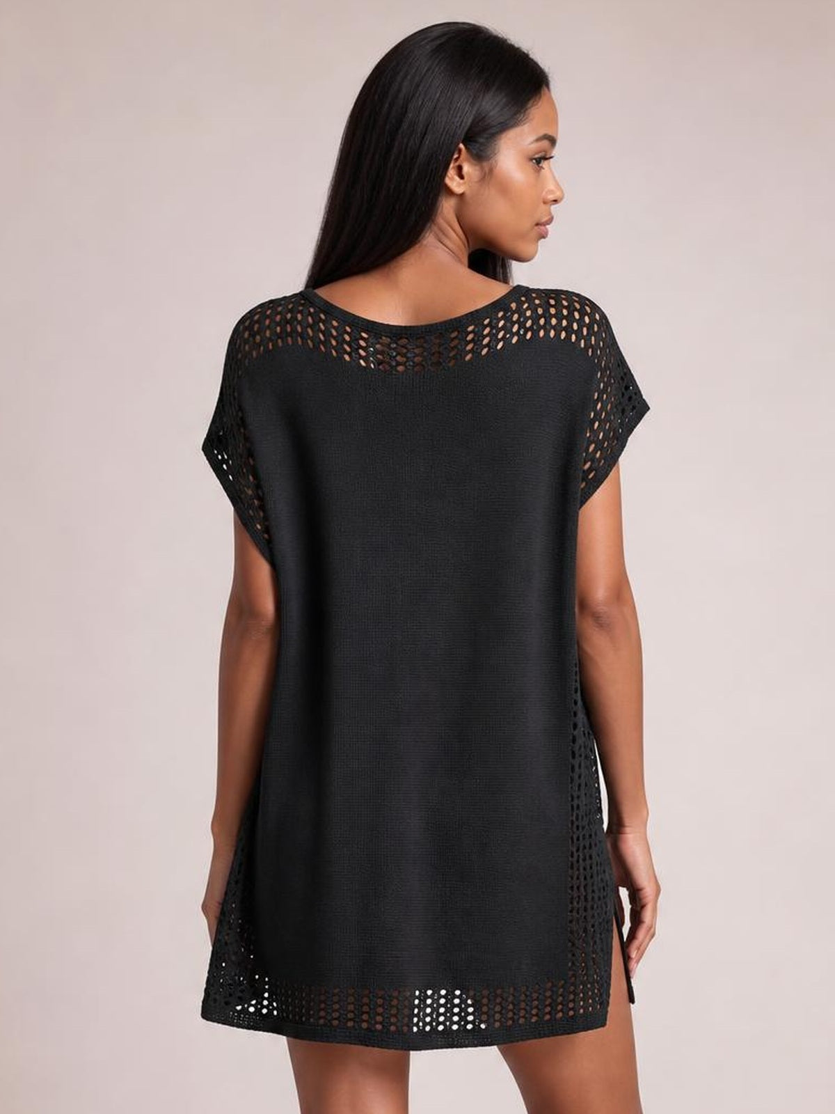 A model stands in profile wearing a black beach cover up dress with crochet-trim openwork at the neckline, sleeves, hem, and side slit.