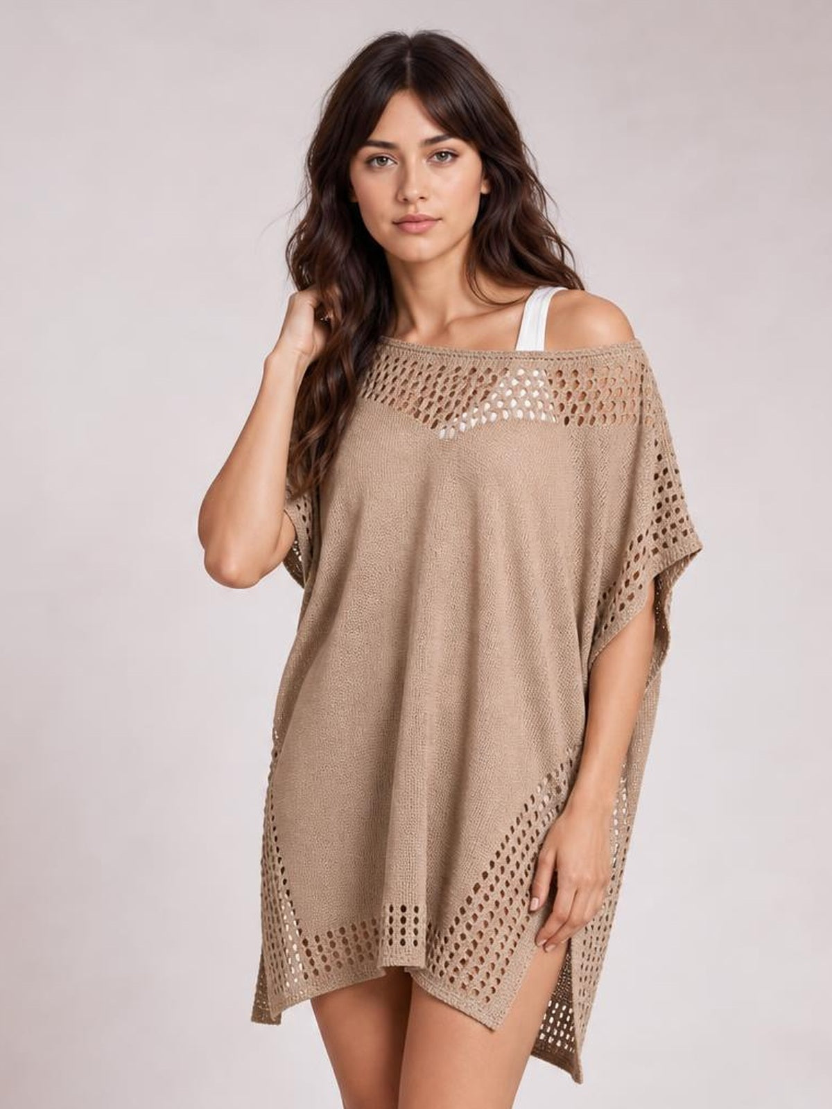 Model poses in a taupe crochet trim beach cover up dress with an off-shoulder neckline, openwork cutouts, side slits, and a loose flowing silhouette.