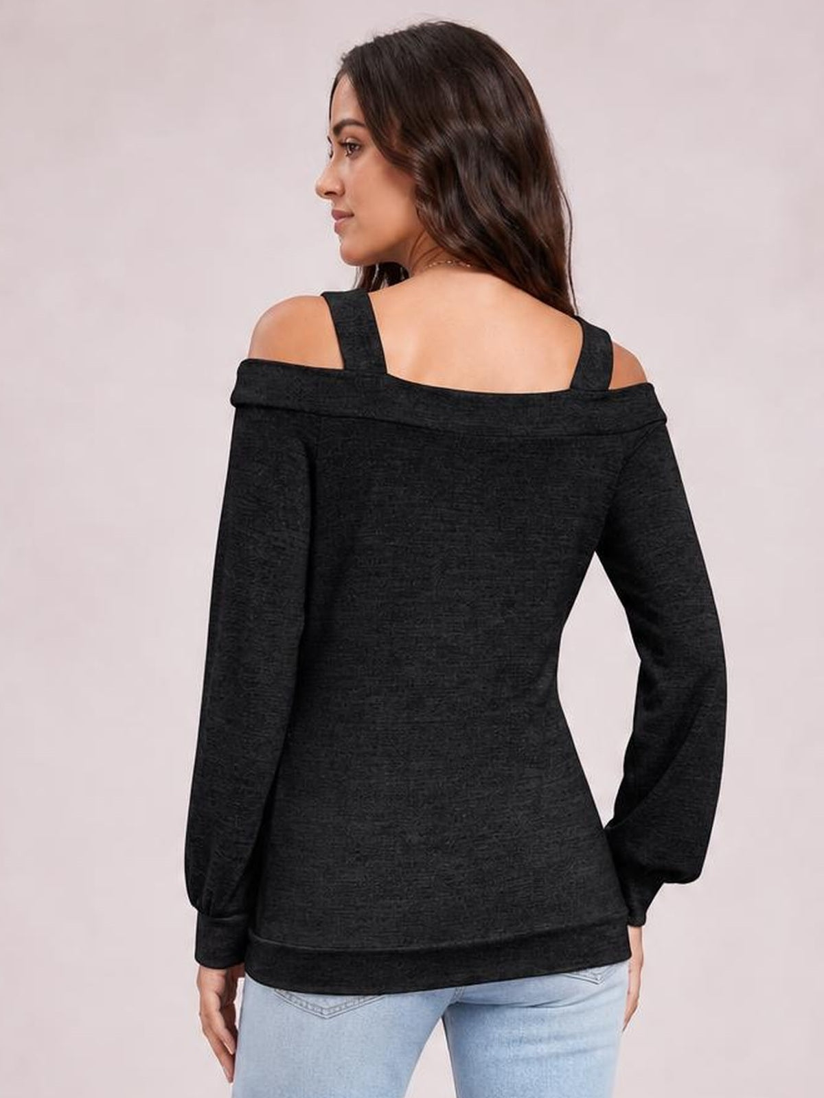 Model shown from the back in a black solid cutout cold-shoulder top with long sleeves, shoulder straps, a wide neckline, and a relaxed regular-length silhouette.
