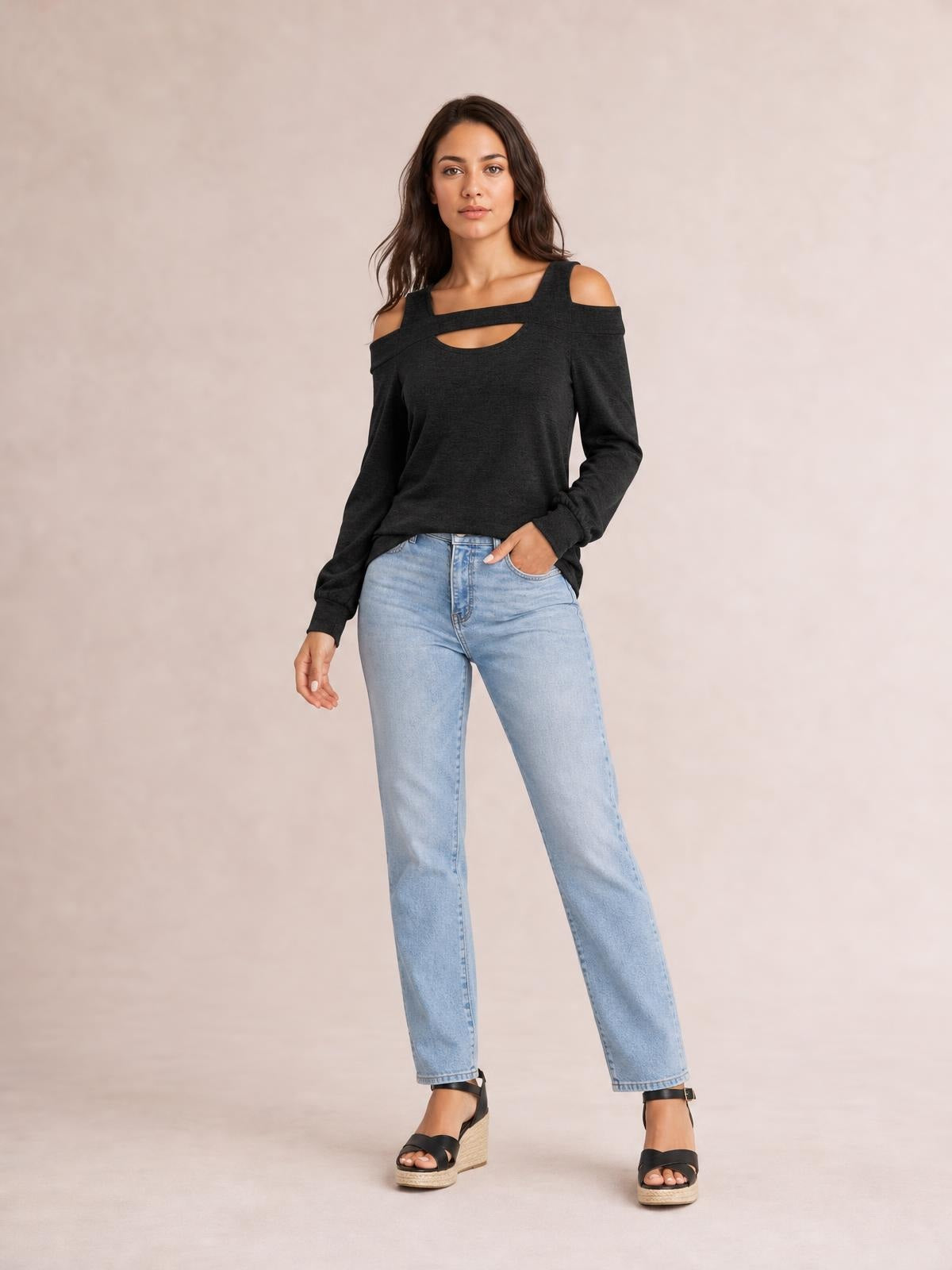 A model poses in a black solid cold-shoulder top with long sleeves, a square neckline, front cutout, and relaxed regular-length silhouette.