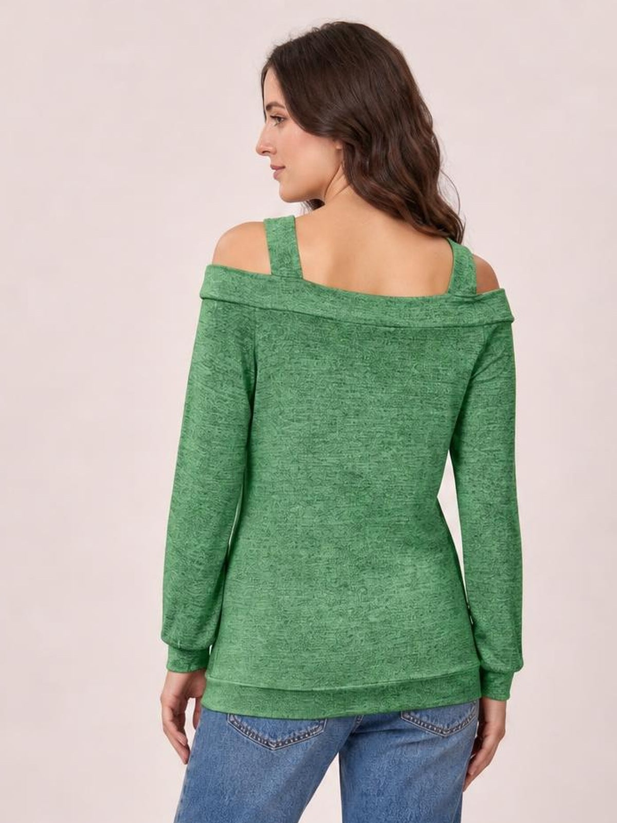A woman stands facing away in a solid green Cutout Cold-Shoulder Top with exposed shoulders, shoulder straps, a wide back neckline, long sleeves, and a regular silhouette.