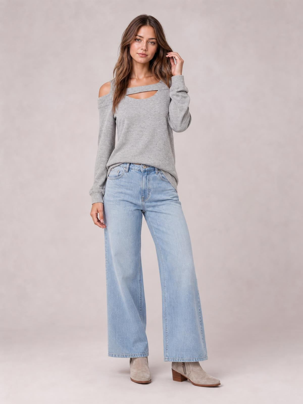 Model poses in a gray solid cutout cold-shoulder top with a square neckline, long sleeves, and a relaxed regular-length silhouette.